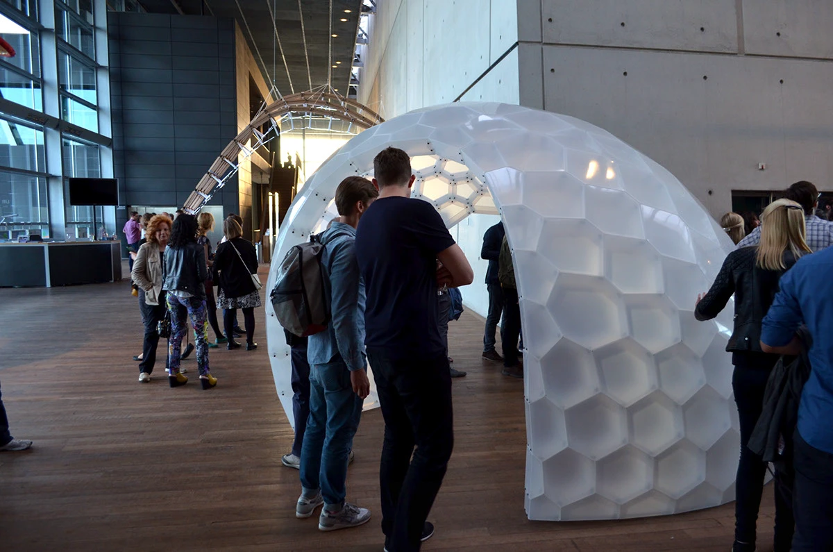 Visitors exploring the PolyShell pavilion at the IASS exhibition.